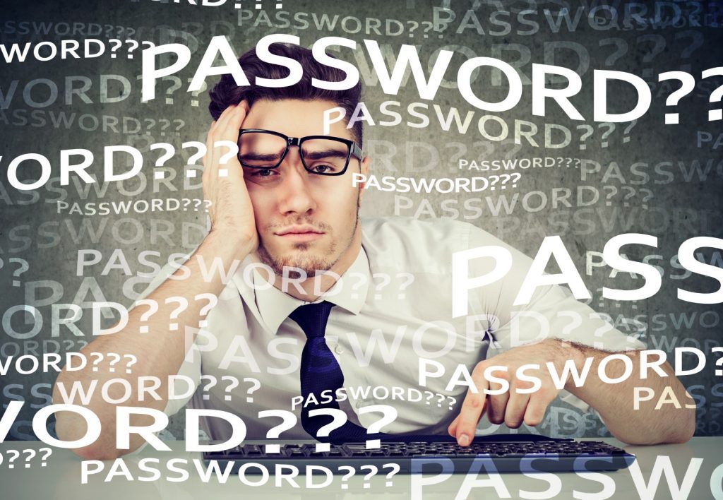 Desperate young business man trying to log into his computer forgot password
