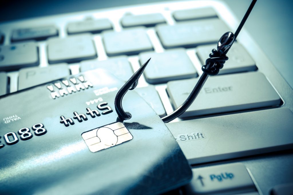 How Tooltips Are Being Used For Phishing - credit card on the end of a fishing hook over computer keyboard