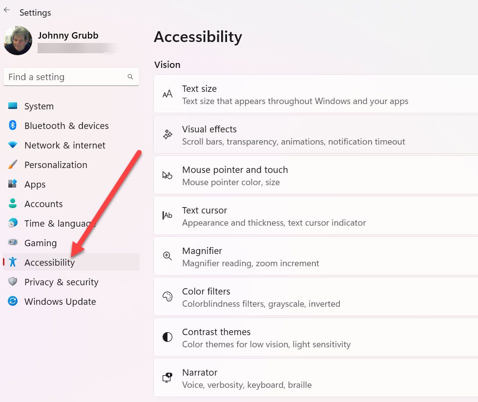 Windows 11 main Settings window with arrow pointing to accessibility.